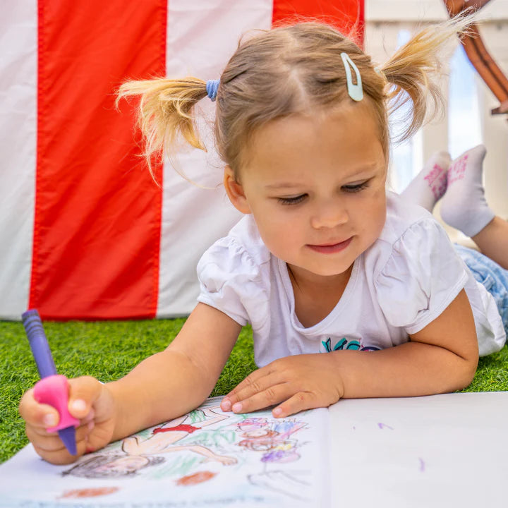 Child using a writing aid fitted on a crayon
