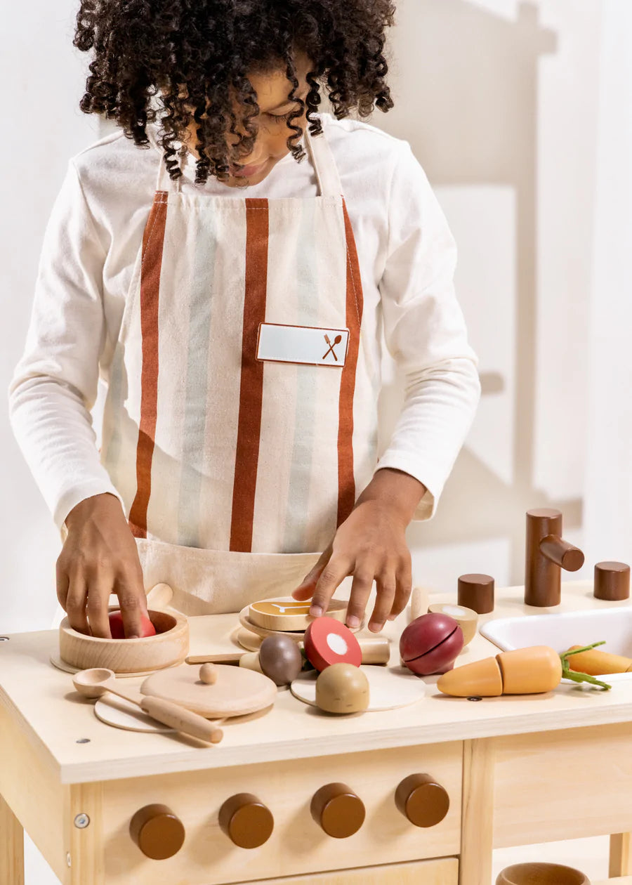 Child chopping on wooden steak and T bone from Cocovillage fish and meat playset
