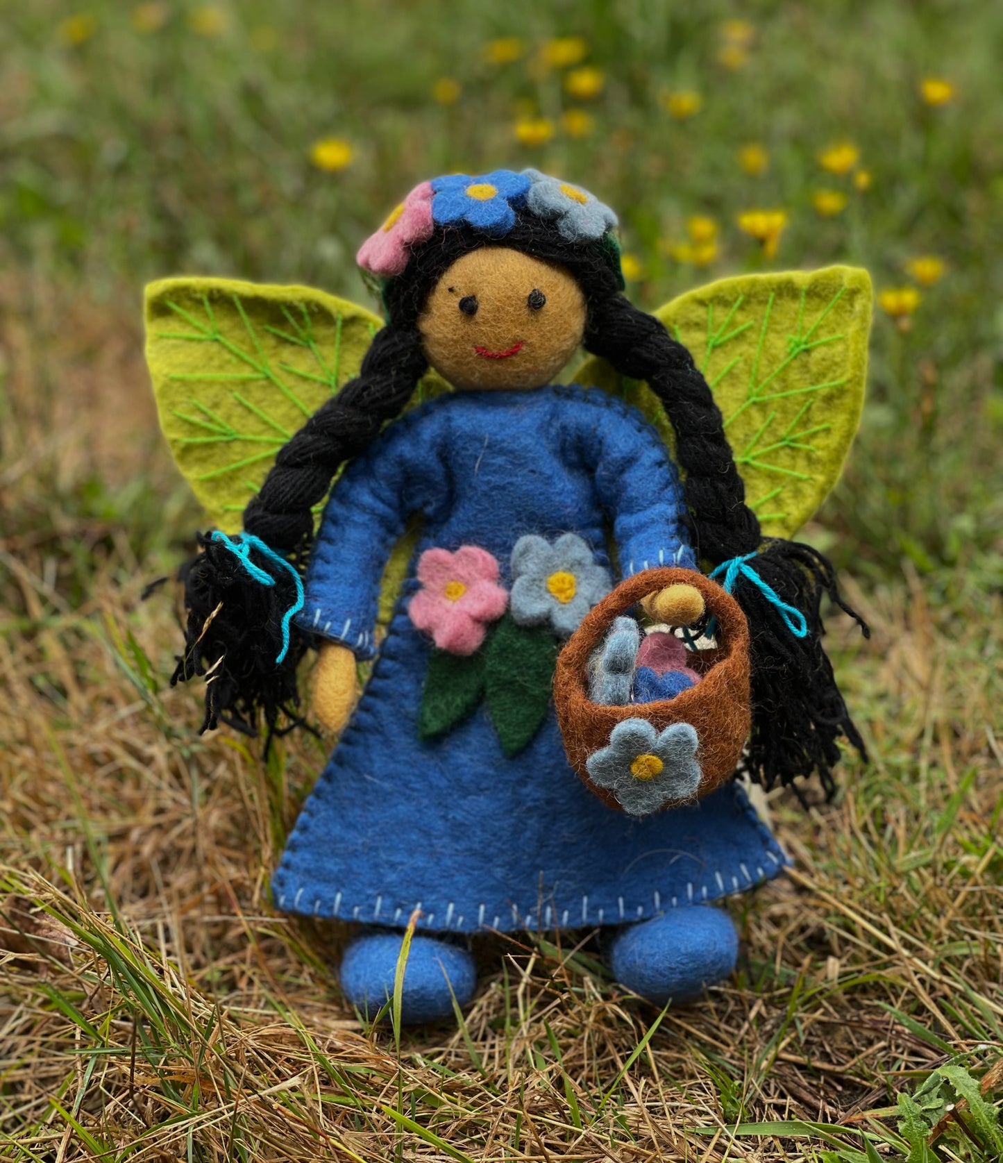 handmade blossom fairy doll in blue gown and sewn flowers, carrying a basket. From Himalayan Felt Co.