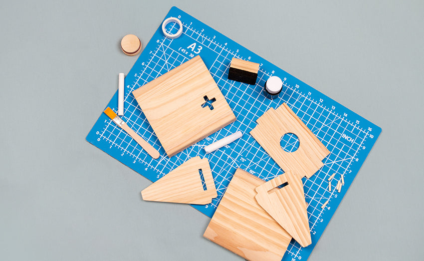 Components of Make Your Own Money Box Kit from Koa Koa, with wooden board, paint, rice paper and chalk