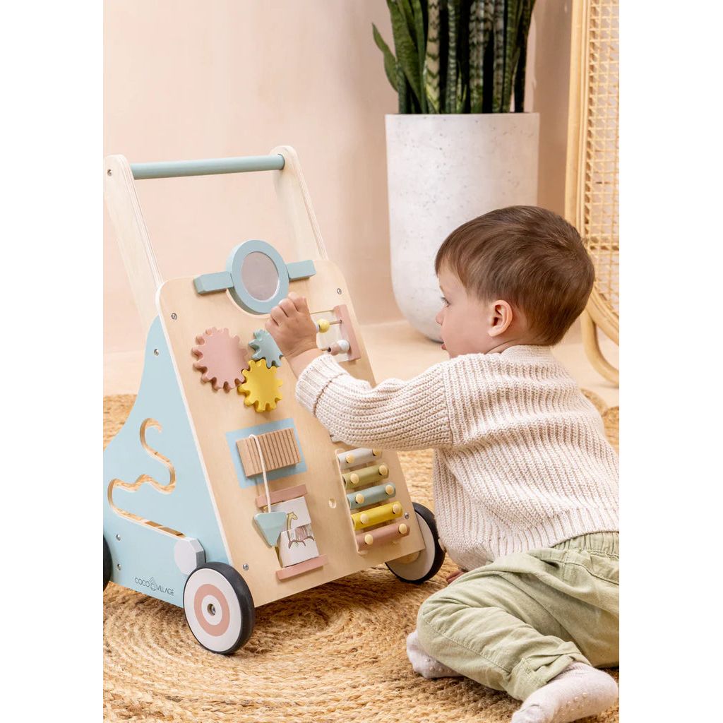 Child playing with gears and beads on Safari busy board and walker
