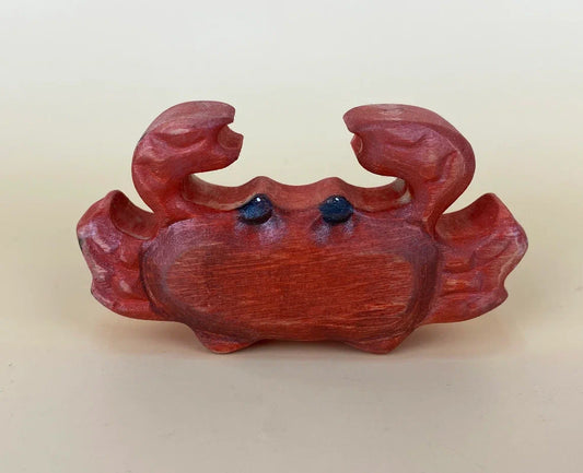 Hand-made reddish-brown wooden toy crab