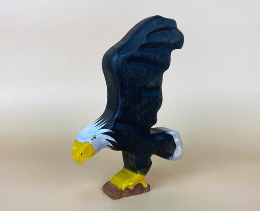hand-made black flying eagle toy in wood with wings spreaded up