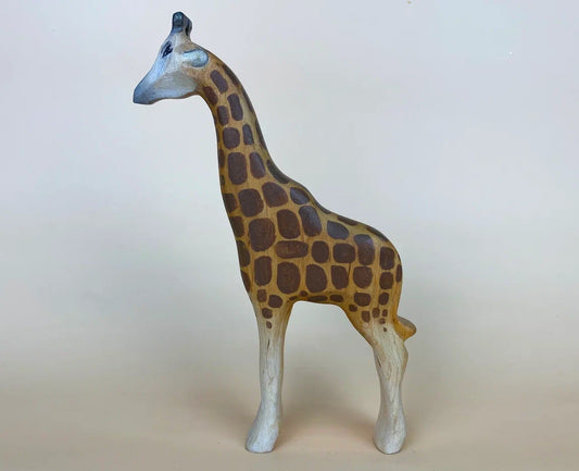 Tall brown wooden toy giraffe with a checkered coat