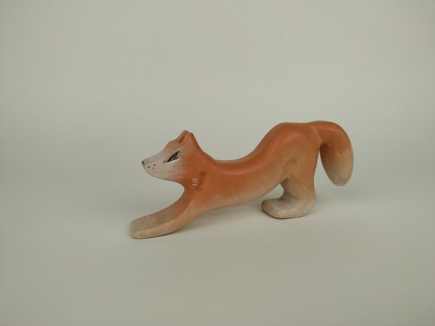 wooden toy fox for toddlers in orange, waiting for pounce