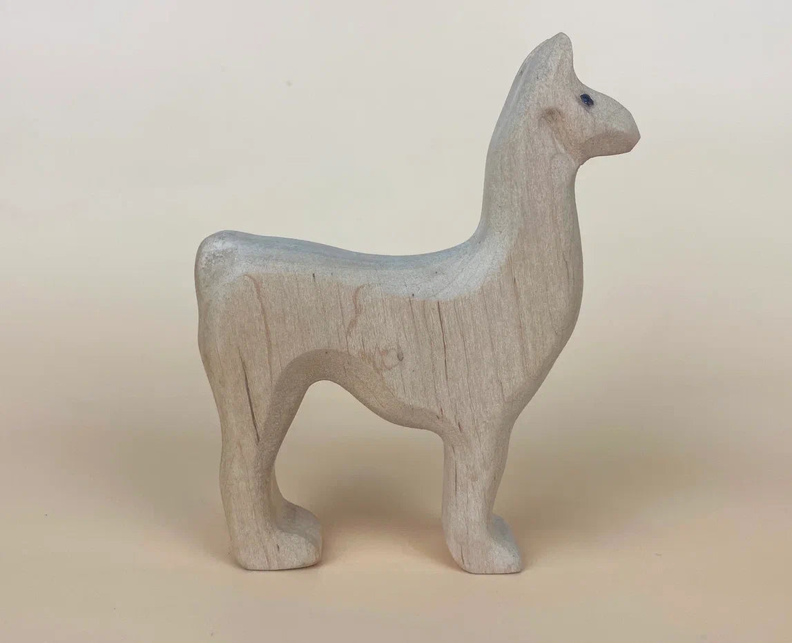 Standing wooden llama  toy in soft beige tones