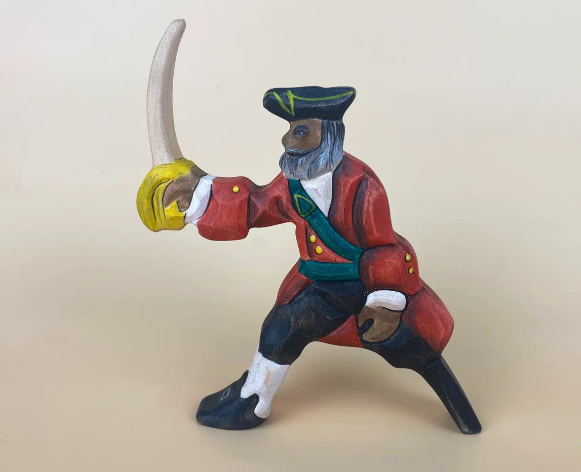 Sword-wielding wooden pirate toy figure in red  robes and a peg-leg