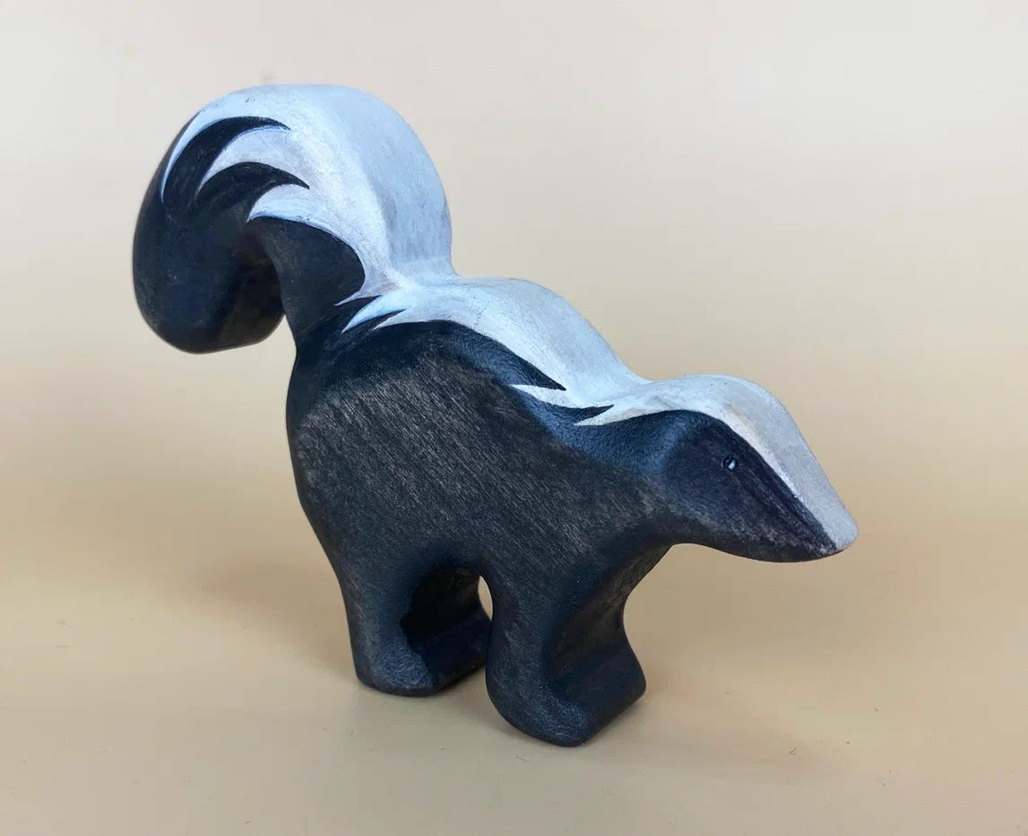 Wooden black toy skunk with bushy tail