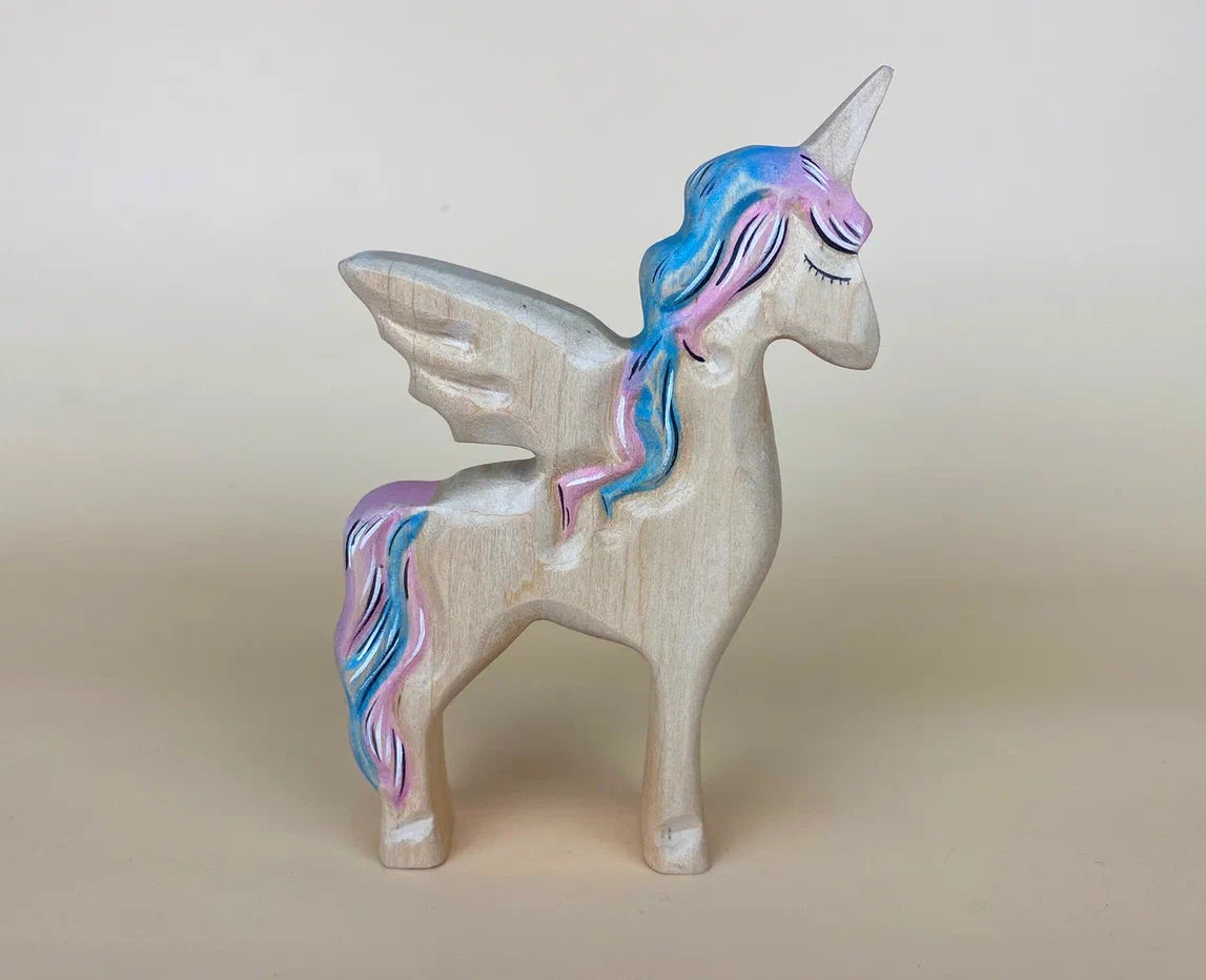 Beautiful white wooden toy unicorn with wings and blue and pink mane and tail