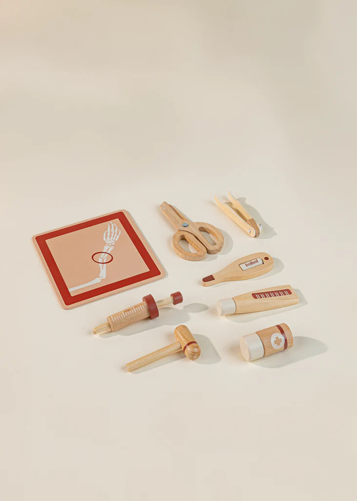 wooden toy syringe, tendon tapper, thermometer and forceps