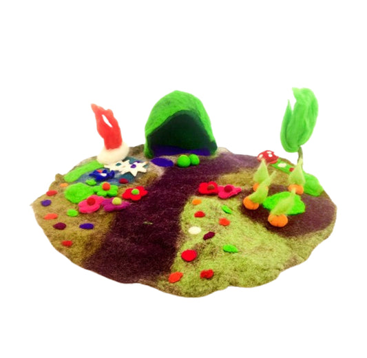 colourful felted play mat with flowers, pathways and an elf home