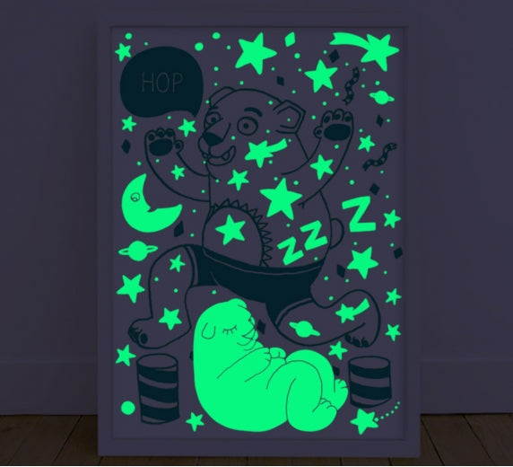 Glow in the dark poster showing luminescent sleeping bear under moon and stars