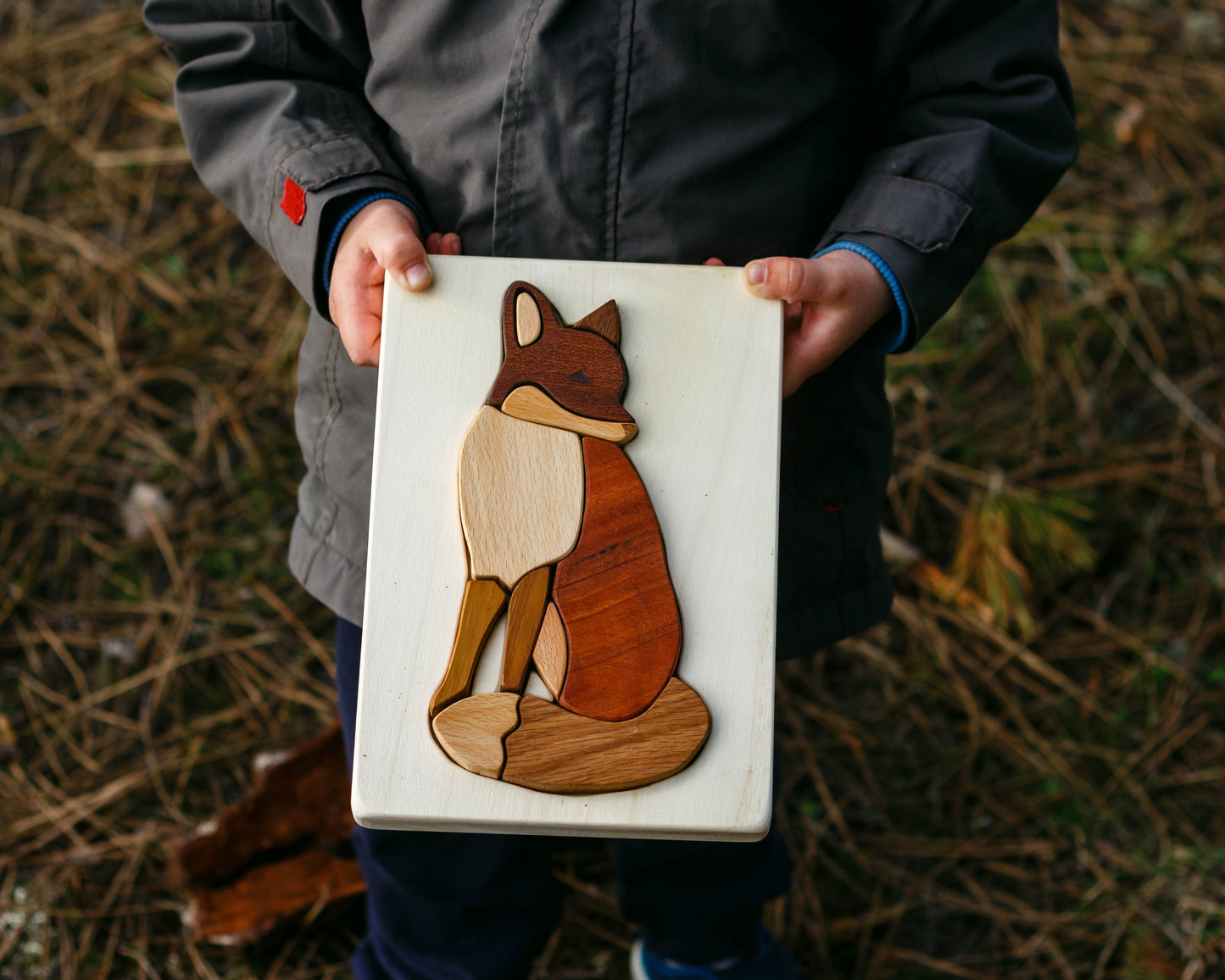 Wooden toy puzzle fox from Cocoletes, carried by a boy on his hands